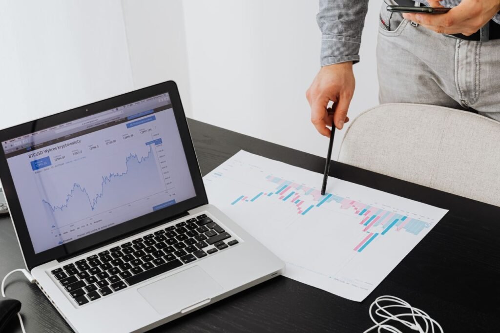 Person analyzing cryptocurrency data using a laptop, highlighting financial insights.